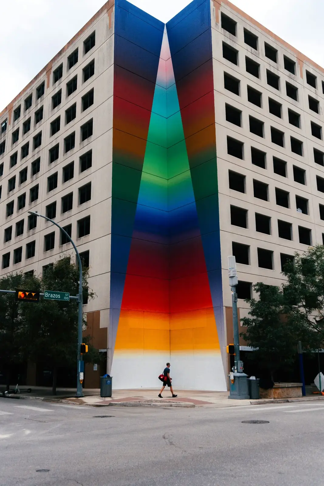 A saturated geometric mural across a downtown Austin building facade